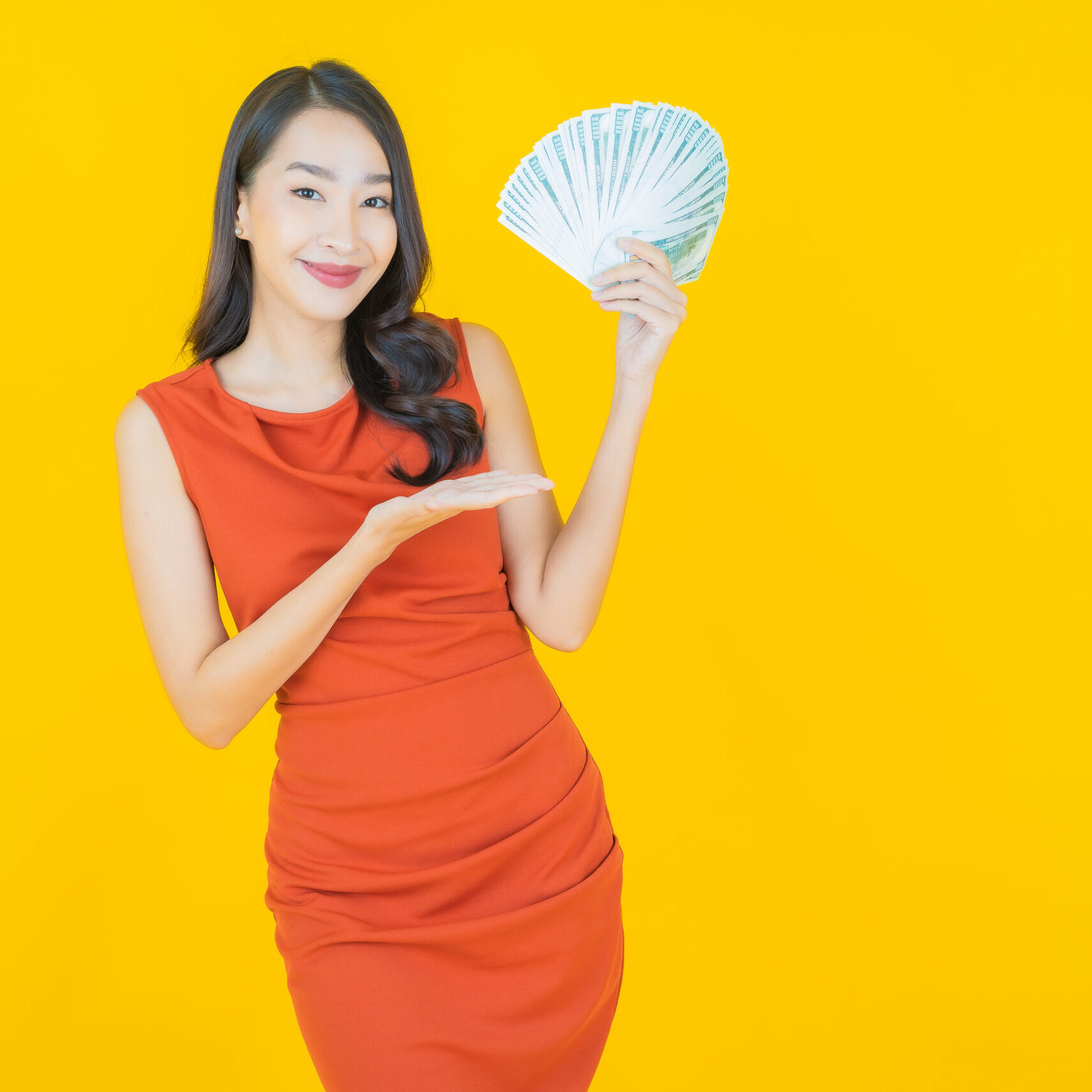 Portrait beautiful young asian woman smile with a lot of cash and money on color background